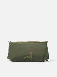 Topologie x Universal Works Rifle Green UW Tech Bottle Sacoche Medium on a white background. The bag is rifle green with beige straps and black zipper pulls.
