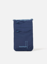 The Topologie x Universal Works Insignia Blue UW Tech Phone Sacoche on a white background. The blue bag has two zipped pockets and logos for both brands.