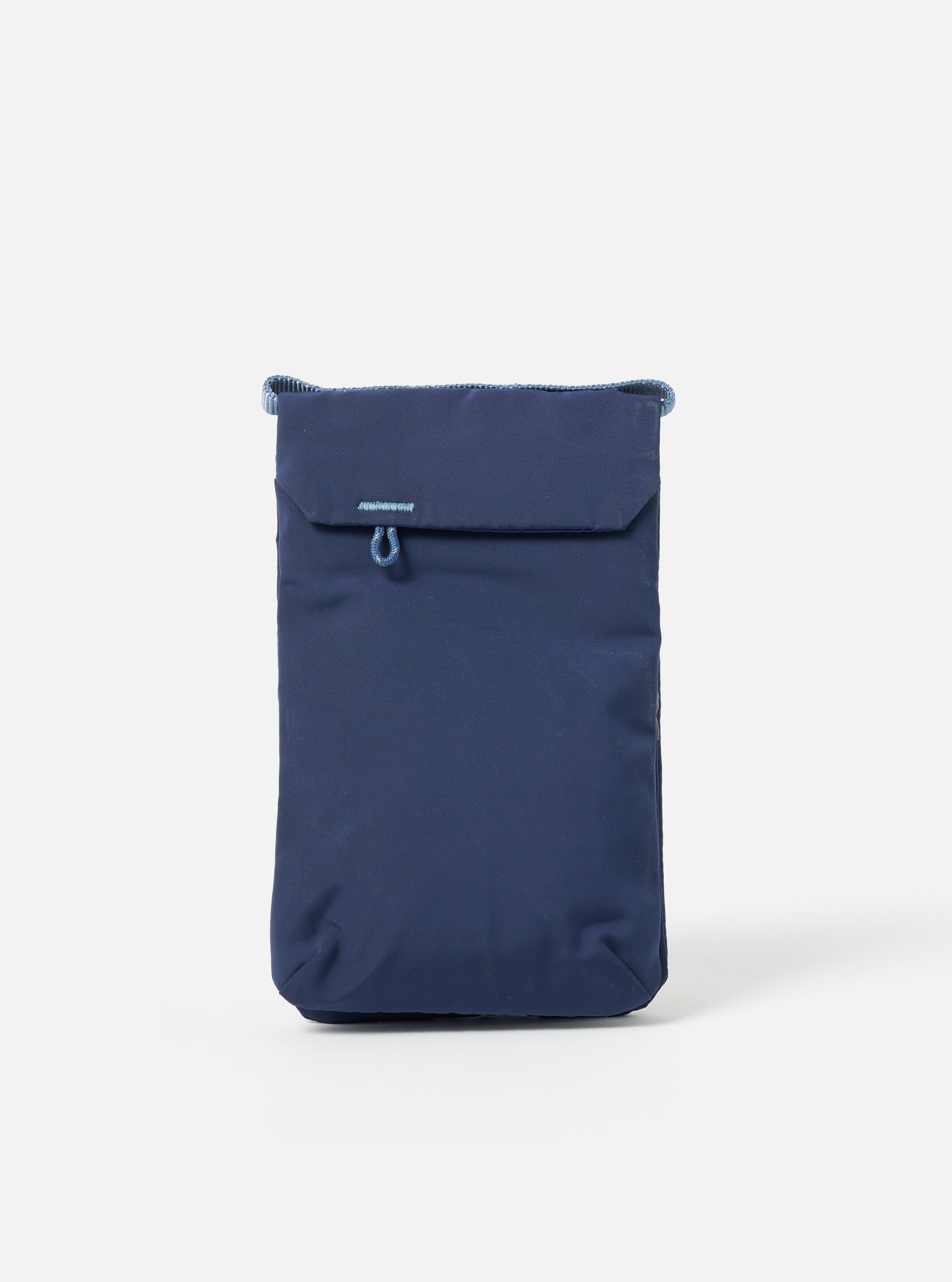 The Topologie x Universal Works Insignia Blue UW Tech Phone Sacoche, a small blue bag with a flap closure, is centered on a white background.