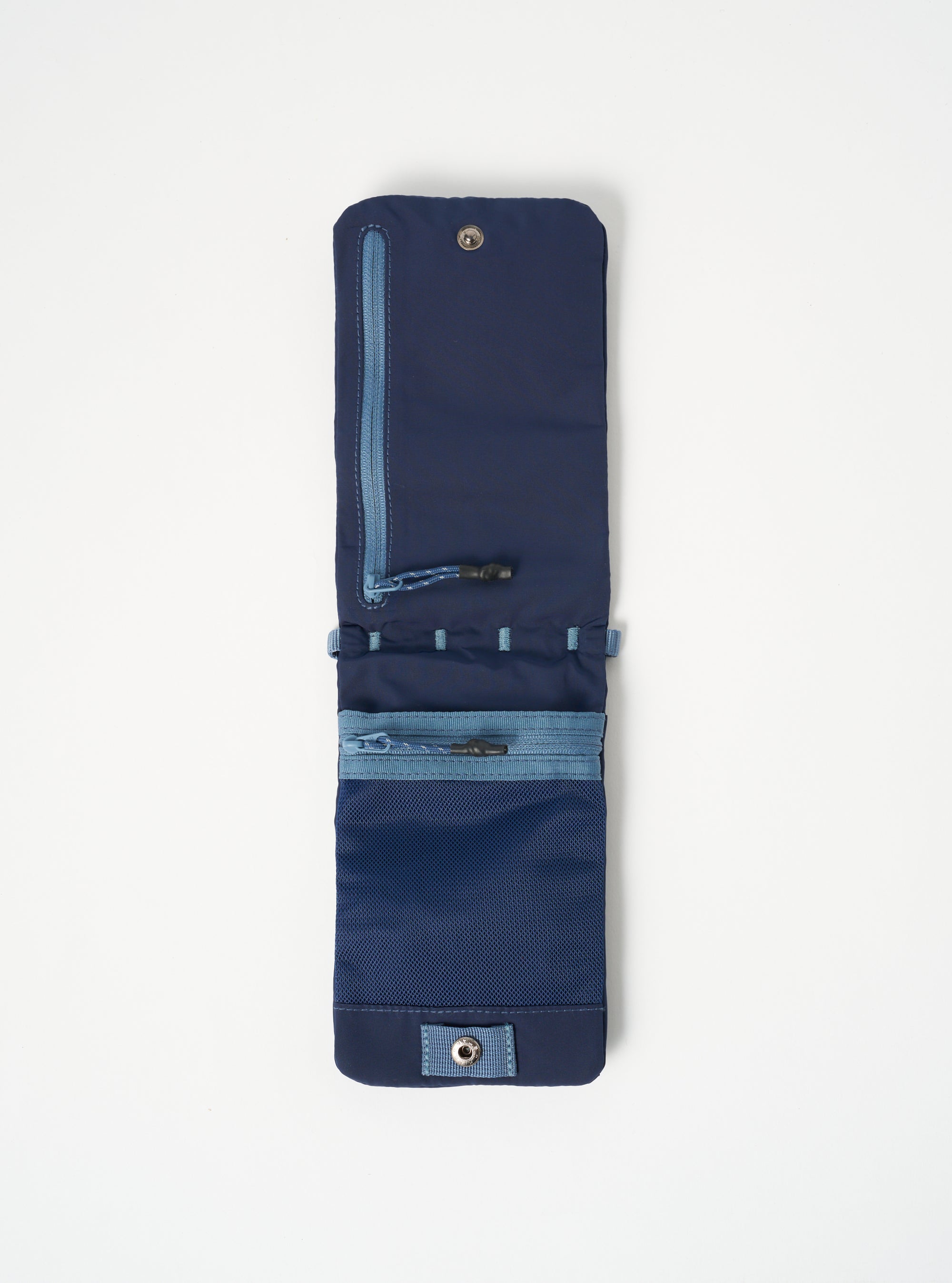 Topologie x Universal Works Insignia Blue UW Tech Phone Sacoche. Blue nylon with zipper and mesh pockets, laid flat on white. 