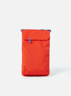 The Topologie x Universal Works Red UW Tech Phone Sacoche, a vibrant red bag with blue accents, is centered on a clean white background. The material appears durable and slightly textured.