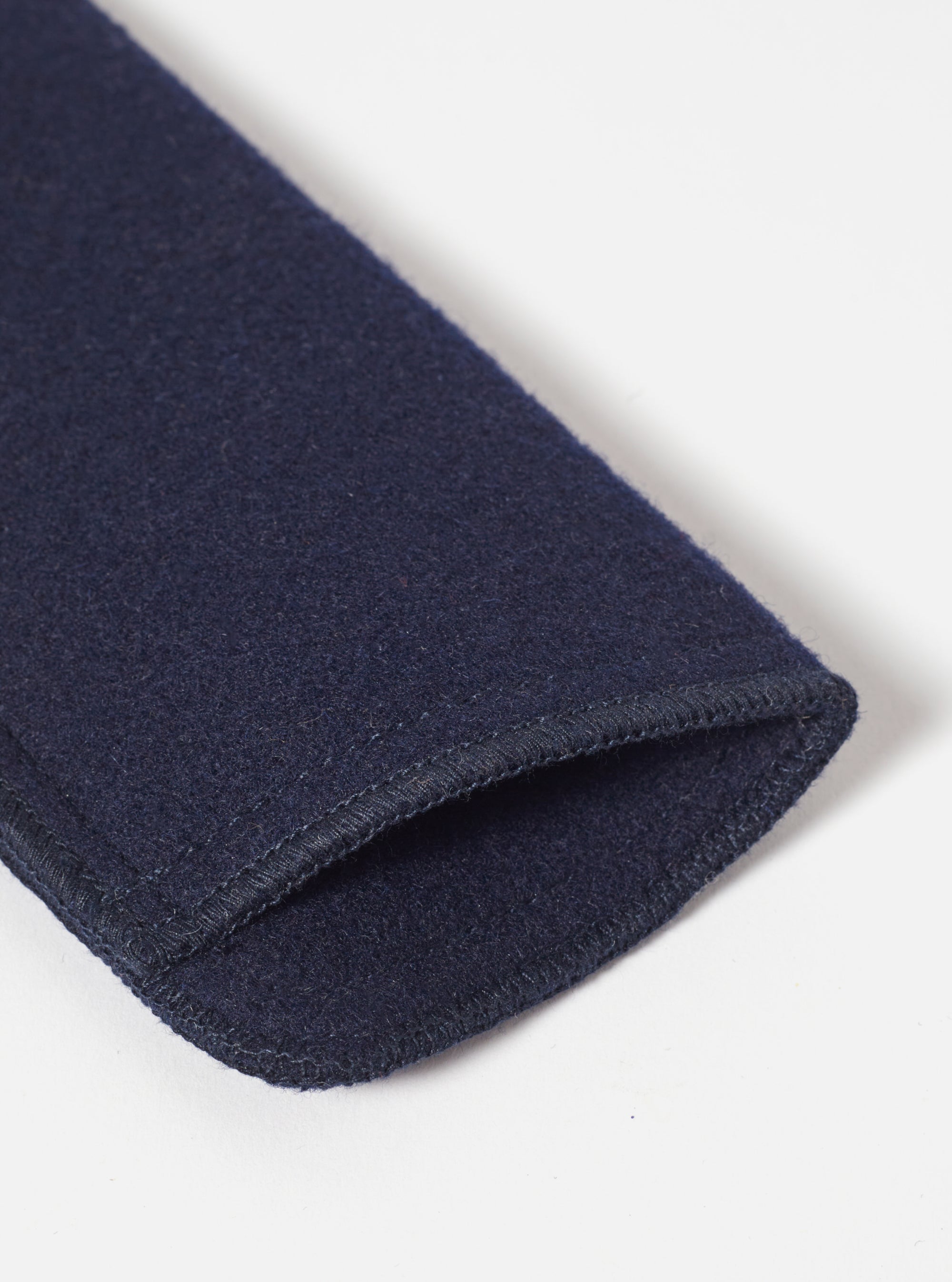 Close-up of the Navy Melton Large Glasses Case, showing the texture of the navy blue melton wool and the stitched edge. Shot on a white background.