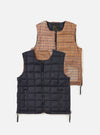 TAION x Universal Works Reversible Dark Navy Military Line Vest on a white background. One side is dark navy puffer, the other is brown and tan plaid. 