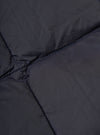 Close-up of the TAION x Universal Works Reversible Dark Navy Military Line Vest, showing the quilted texture and dark navy color. The fabric is smooth with subtle stitching.