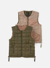 The TAION x Universal Works Reversible Dark Olive Military Line Vest, displayed on a white background. One side is dark olive, the other is a brown and beige houndstooth pattern.