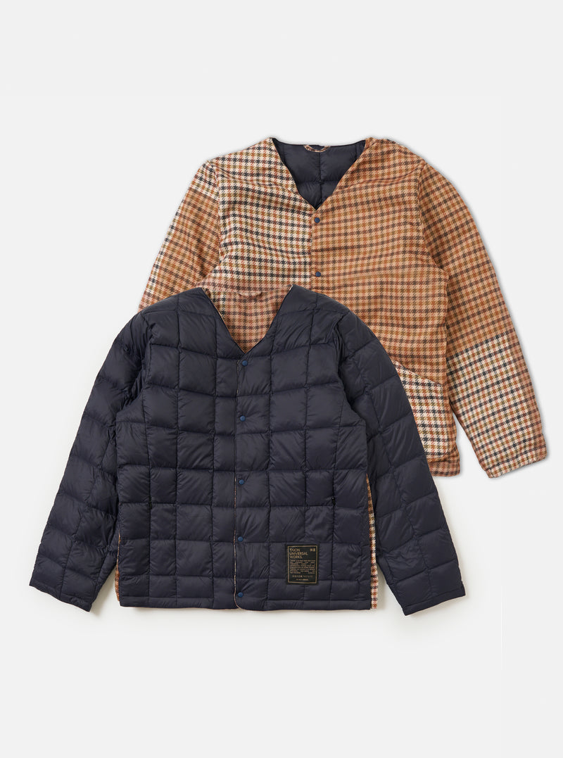 The TAION x Universal Works Reversible Dark Navy Military Line Liner Jacket. One side is dark navy quilted, the other is brown and tan houndstooth. Shot on a white background.