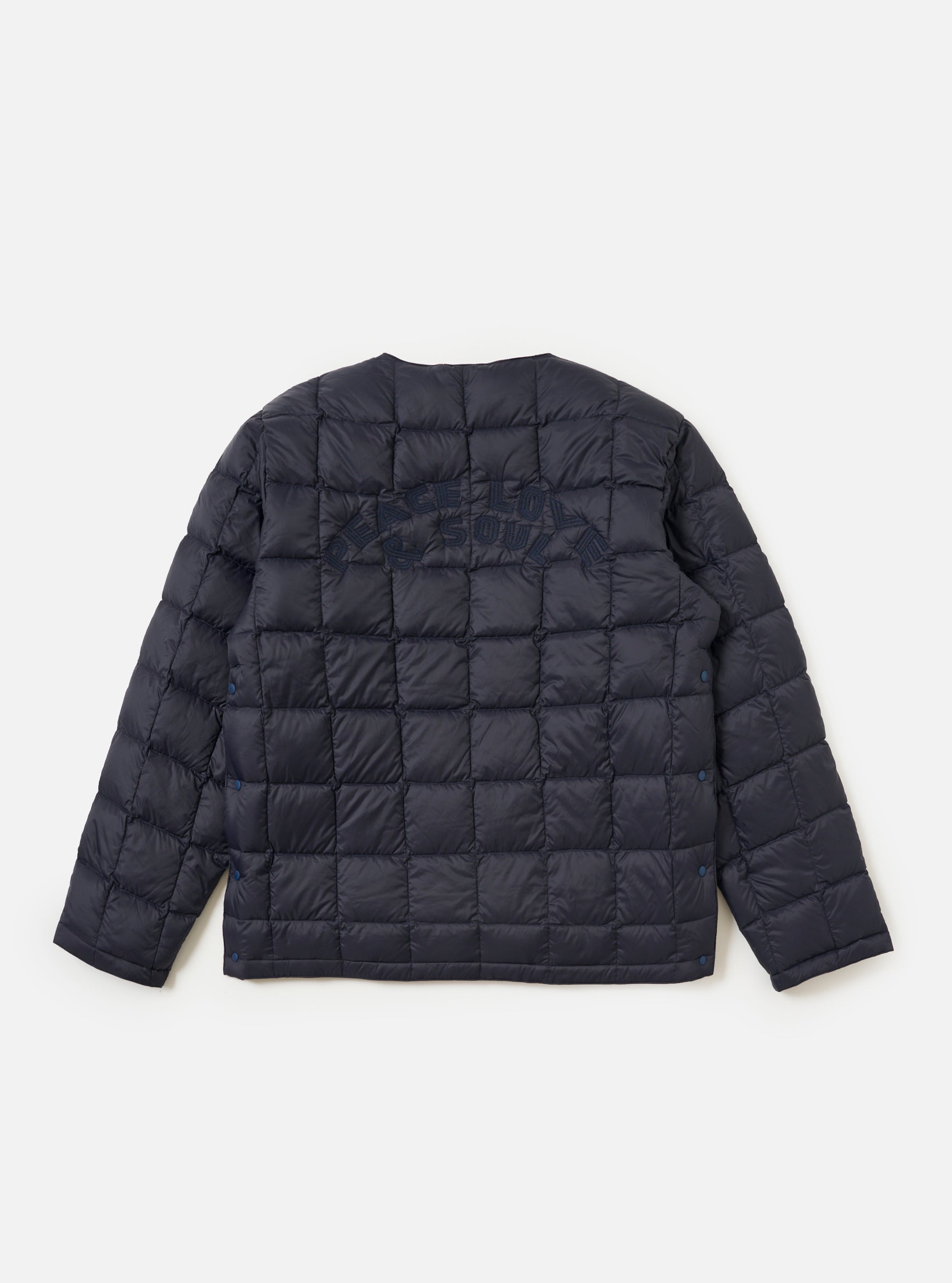 The TAION x Universal Works Reversible Dark Navy Military Line Liner Jacket is displayed on a white background. The quilted jacket has dark navy embroidery on the back.