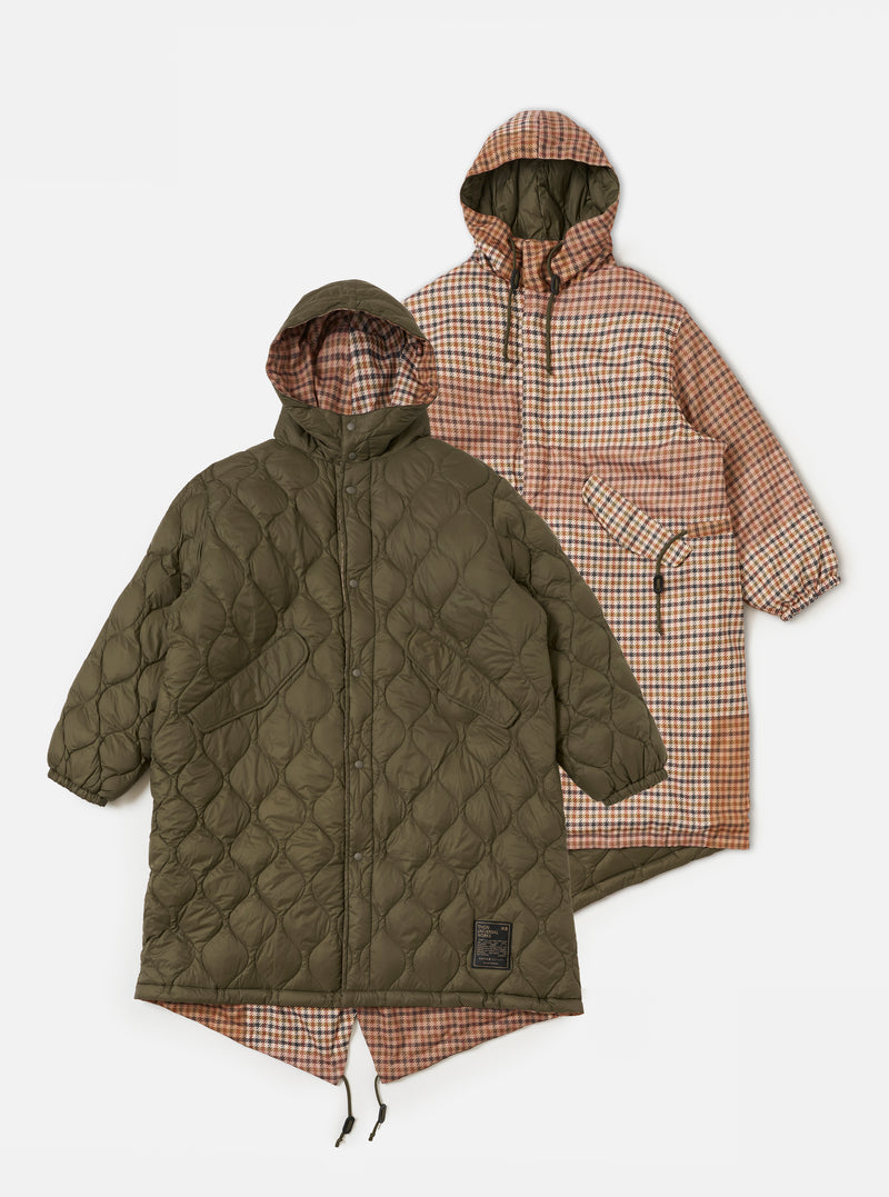 Two TAION x Universal Works Reversible Dark Olive Military Line Parkas on a white background. One is quilted olive, the other is brown plaid. Both have hoods.