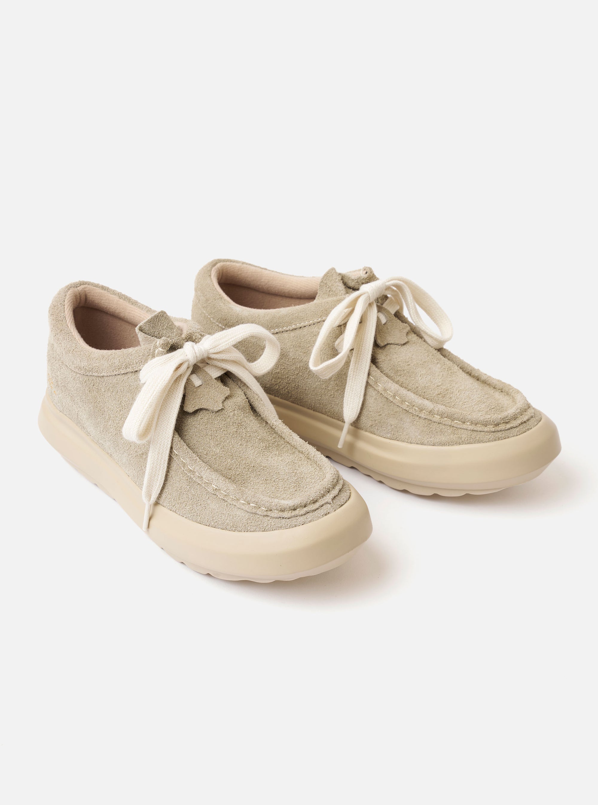 The Wander etc. FD/08 in Dust/Off White Suede/Leather is shown from a rear angle against a plain white background. The shoe features a textured, light dust-colored hairy suede upper and a thick, off-white cushioned outsole. A branded pull tab is visible on the heel, and the chunky laces are tied at the front.
