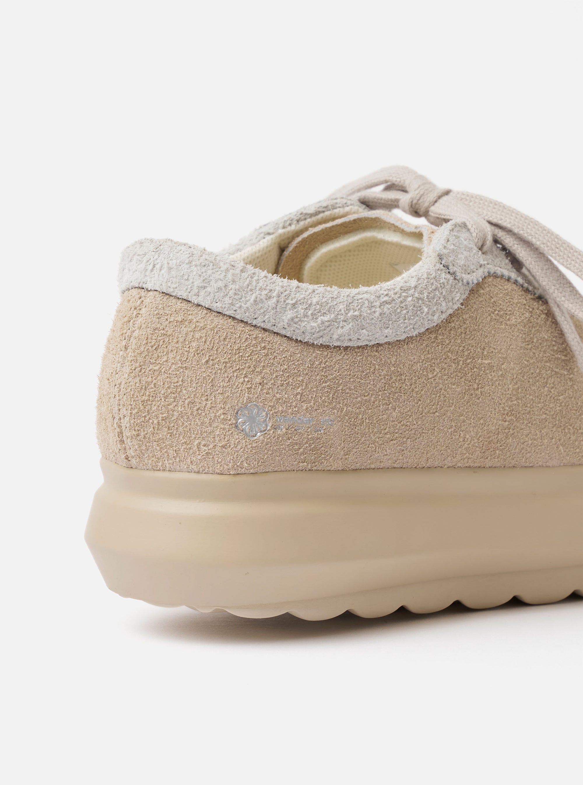 The Wander etc. 'The 70's' in Bone Hairy Suede/Leather is shown from the back as a flat lay against a plain white background. The image highlights the chunky, textured off-white rubber outsole and the heel of the shoe, which is constructed from bone-colored hairy suede with tonal stitching.