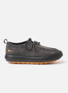 The Wander etc. FD/08 Low in Black Asphalt/Gum Hairy Suede is shown in a studio shot against a plain white background. The shoe features a black hairy suede upper with a low-cut silhouette, slim black laces, and a prominent chunky gum rubber sole. The textured finish of the suede and the contrast between the black upper and the tan-colored sole are clearly visible.