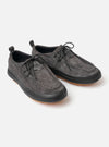The Wander etc. FD/08 Low in Black Asphalt/Gum Hairy Suede is shown from a side profile as a flat lay against a plain white background. The shoe features a black hairy suede upper, slim black laces, and a chunky gum rubber outsole. A small branded tag is visible on the heel.
