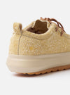 The Wander etc. FD/08 Low in Dune/Gum Hairy Suede is shown from a rear angle as a flat lay against a plain white background. The image highlights the shoe's heel, featuring a pull tab and branding, along with the thick gum-colored rubber outsole. The textured dune-colored hairy suede upper and the chunky laces are also prominent.