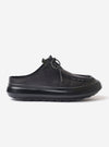 The Wander etc. Laze in Black Nappa Leather is shown as a flat lay against a plain white background. The footwear is a backless mule style featuring a smooth black nappa leather upper with a rounded toe. A thick, textured black phylon and gum outsole provides a chunky profile, while the interior shows a natural cork insole.
