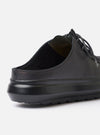 The Wander etc. Laze in Black Nappa Leather is shown as a flat lay against a plain white background. The footwear features a backless mule silhouette with a smooth black nappa leather upper and a signature chunky black outsole. The image highlights the clean slip-on design and the substantial profile of the sole.