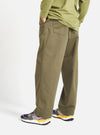 A person in a light olive long sleeve shirt and Light Olive Twill Duke Pant, standing against a white backdrop. The pants are a relaxed fit and made of twill.