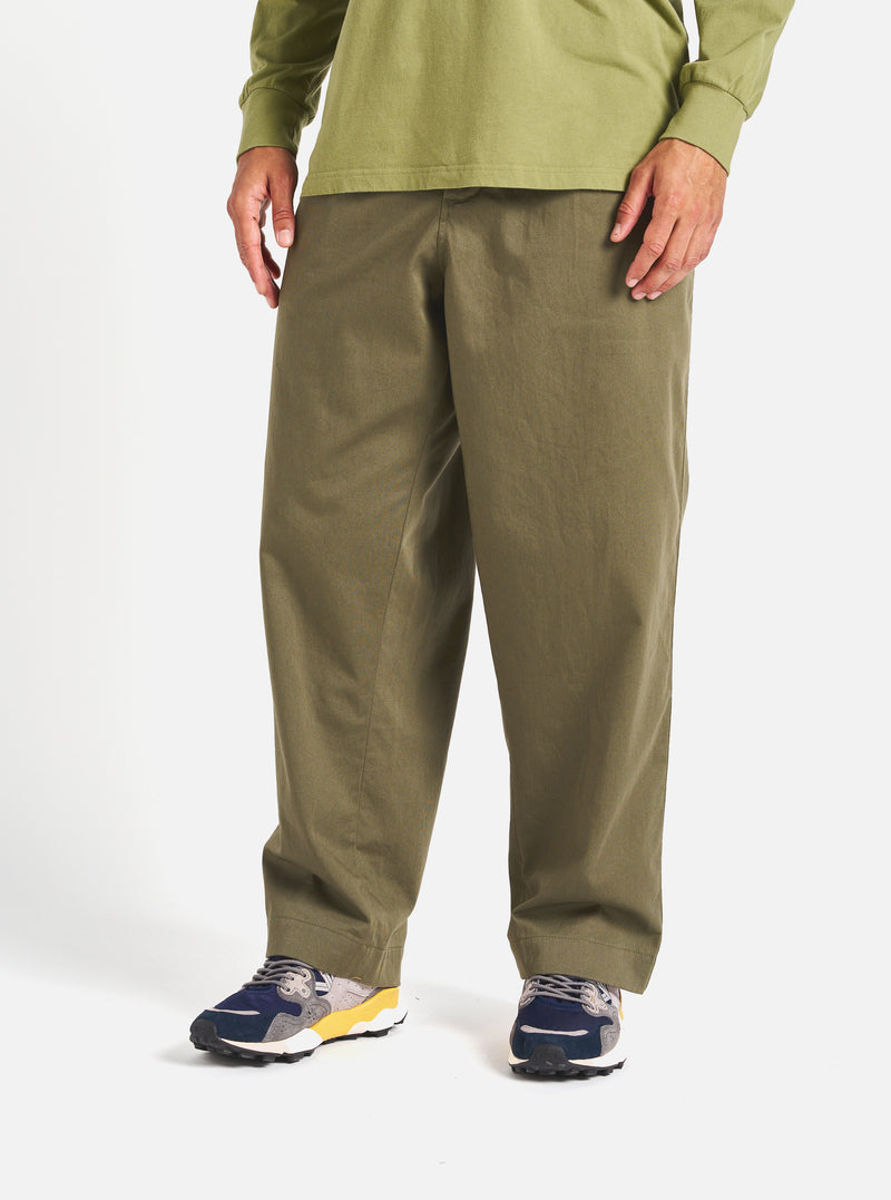 A model wears the Light Olive Twill Duke Pant, a relaxed fit twill pant, in front of a white background.