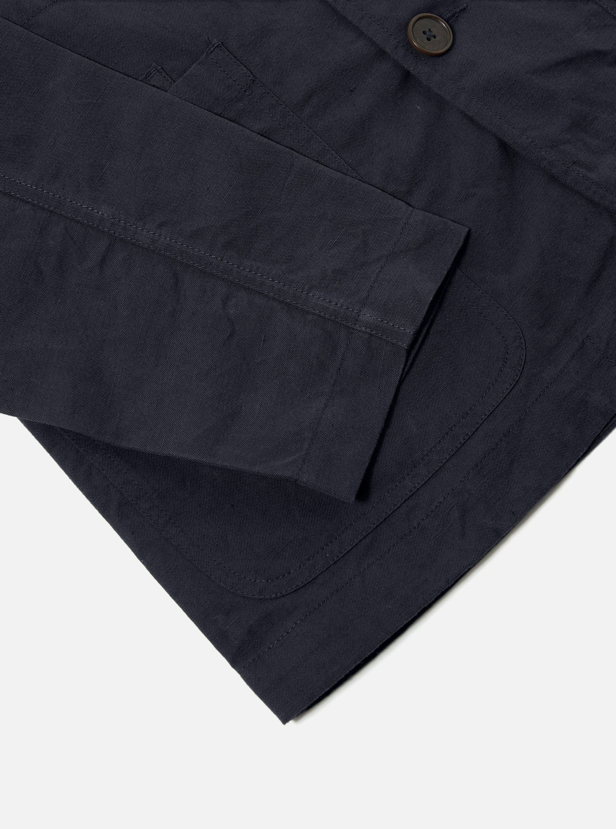 Close-up of the navy Linen Slub Weave Bakers Jacket on a white background, showcasing the fabric texture and button details.