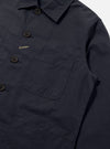 Close-up of the Navy Linen Slub Weave Bakers Jacket on a white background. The jacket features a button-up front and patch pockets.