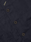Close-up of the Navy Linen Slub Weave Bakers Jacket showing the linen texture, button details, and pocket stitching. The jacket is laid flat on a neutral surface.