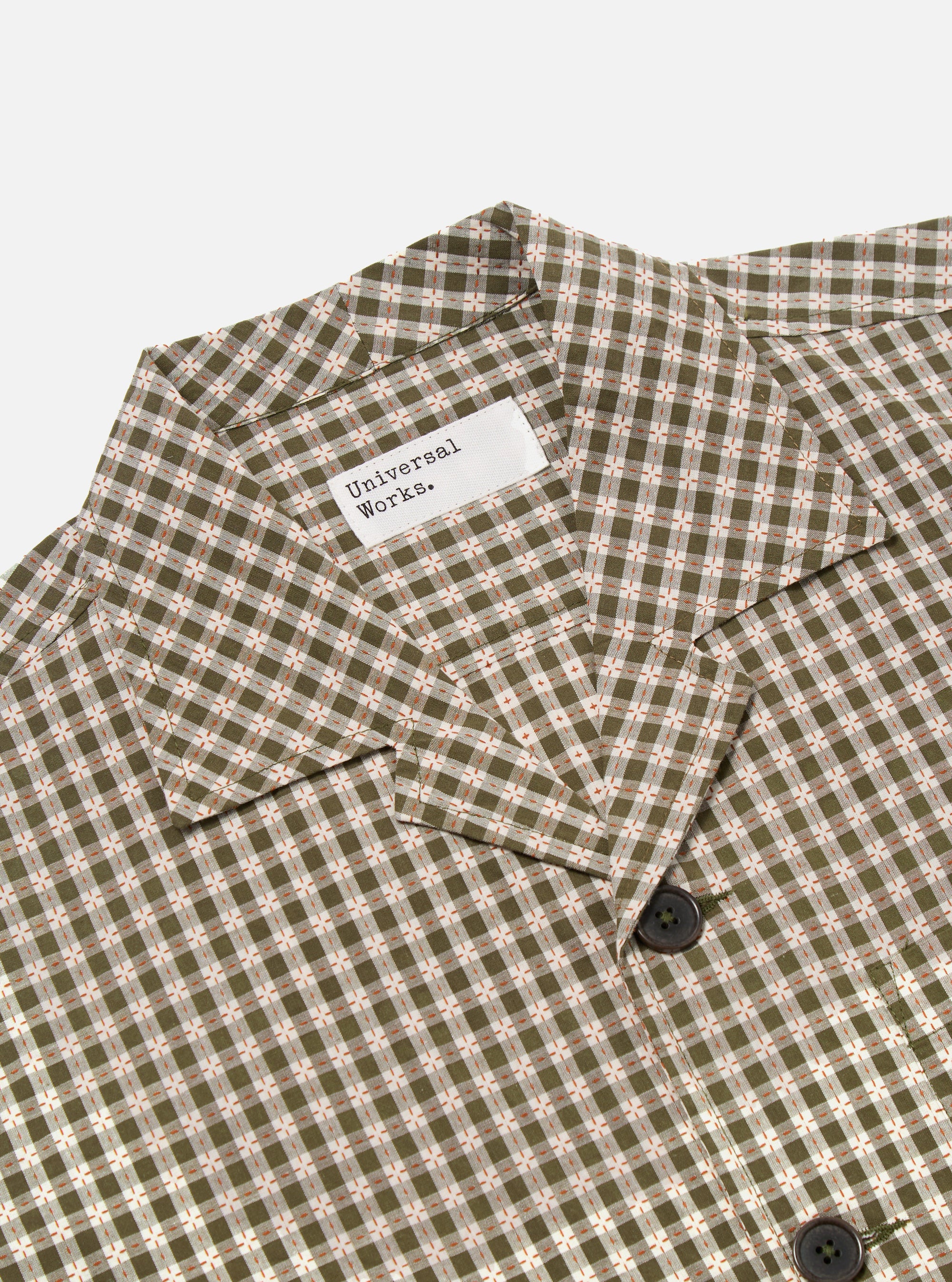 Close-up of the Olive Dobby Check Cancun Jacket on a white background. The jacket has an olive, white, and orange check pattern and dark buttons.