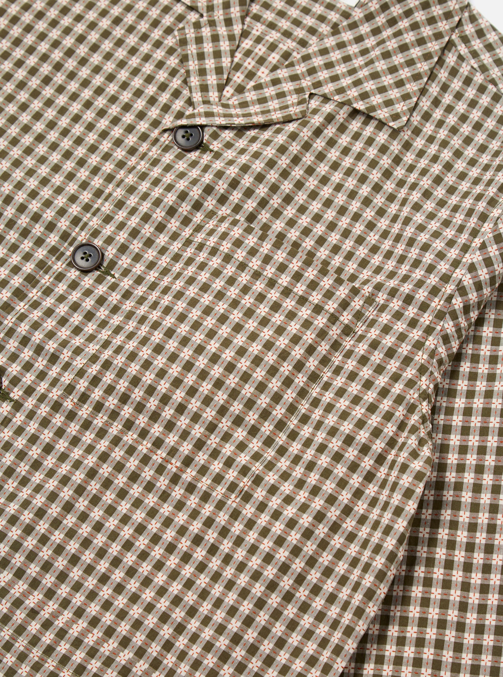Close-up of the Olive Dobby Check Cancun Jacket. Features an olive and white check pattern with brown buttons. The jacket is on a white background.