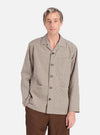 A man models the Olive Dobby Check Cancun Jacket against a white background. The jacket features an olive and white check pattern and a relaxed fit.