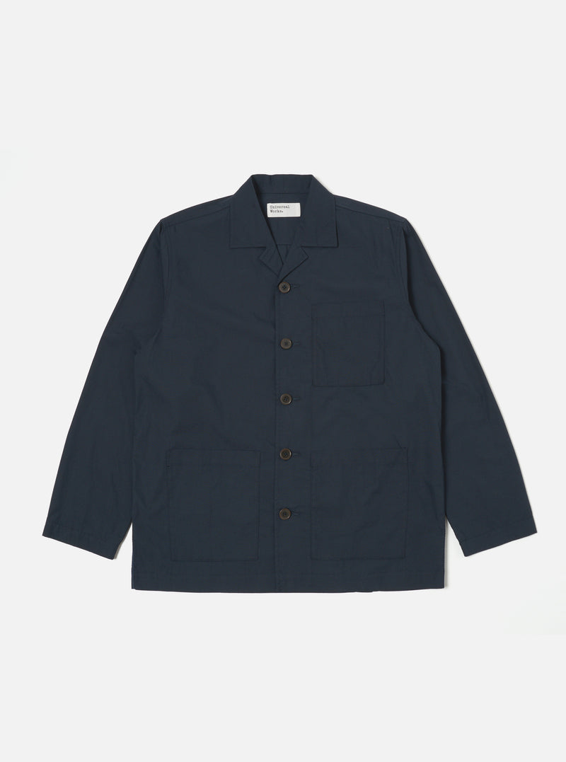 The Navy Broadcloth Cancun Jacket is displayed on a white background. The jacket is a dark navy color and has a relaxed fit. It features a button-down front and three pockets.