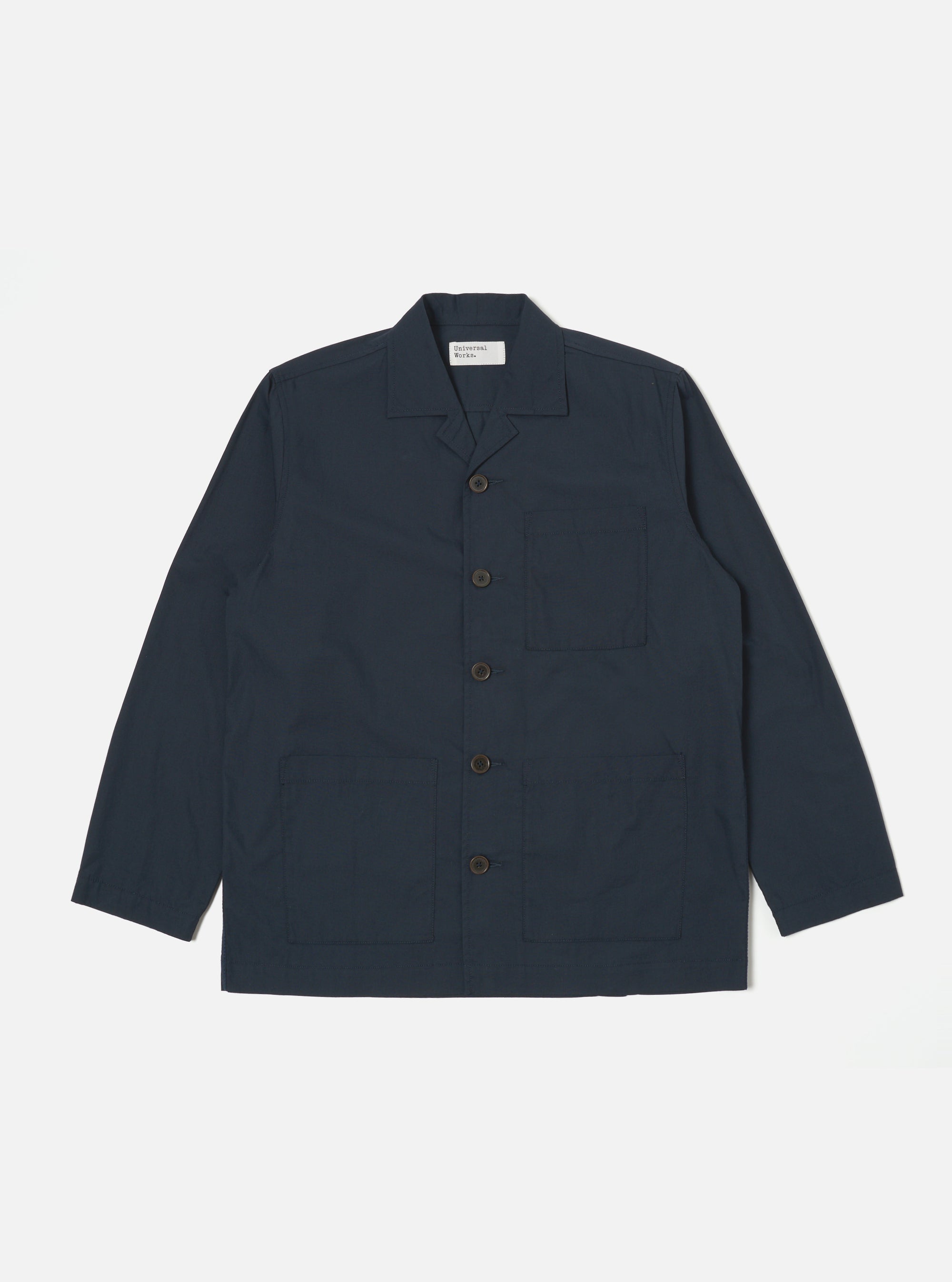 The Navy Broadcloth Cancun Jacket is displayed on a white background. The jacket is a dark navy color and has a relaxed fit. It features a button-down front and three pockets.
