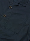 Close-up of the navy Broadcloth Cancun Jacket showing the fabric texture, pocket, and button details. The jacket is laid flat on a neutral surface.