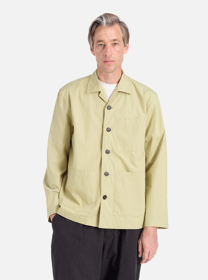 A model wears the Pale Green Broadcloth Cancun Jacket. The broadcloth jacket has a relaxed fit. Shot against a white background.