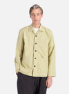 A model wears the Pale Green Broadcloth Cancun Jacket. The broadcloth jacket has a relaxed fit. Shot against a white background.