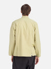 Back view of a model wearing a Pale Green Broadcloth Cancun Jacket. The jacket is broadcloth and pale green. The background is a clean, bright white.