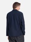 Back view of a model wearing the Navy Broadcloth Cancun Jacket. The jacket is a deep navy color, and the background is a clean, bright white.