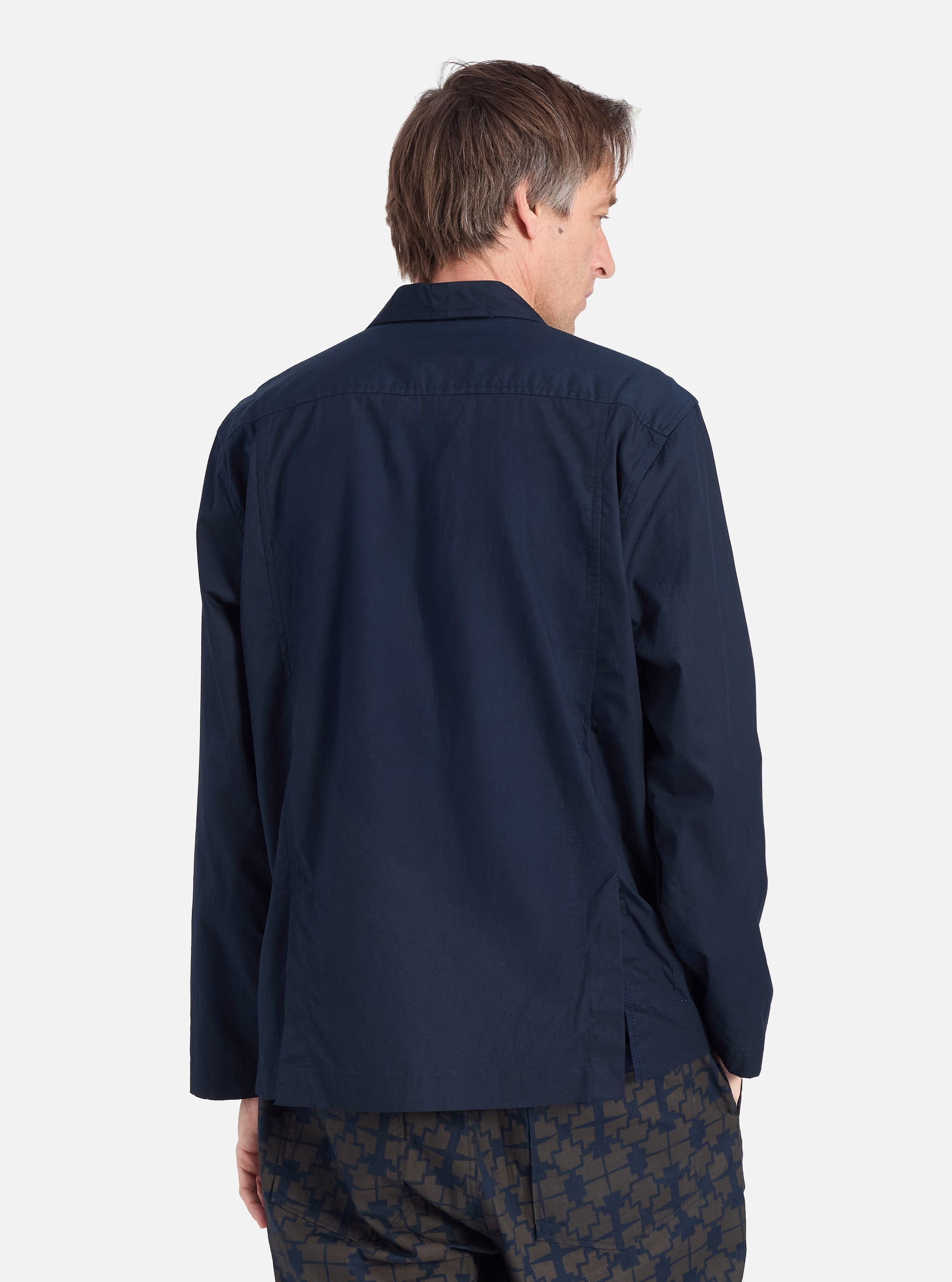 Back view of a model wearing the Navy Broadcloth Cancun Jacket. The jacket is a deep navy color, and the background is a clean, bright white.