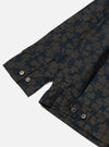 Close-up of the Navy Mitla Print Cotton Rose Bowl Jacket sleeve. The jacket has a navy and brown geometric print and brown buttons. Shot on a white background.