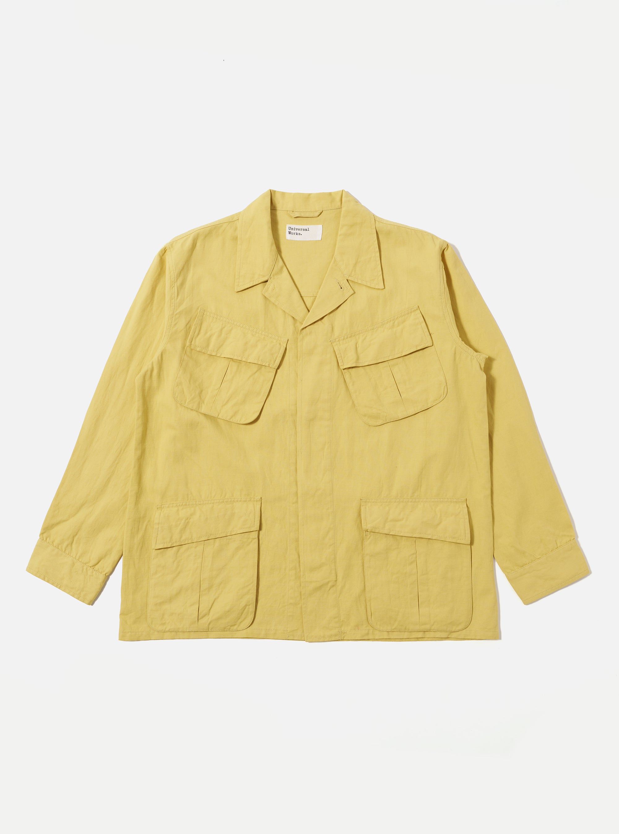 Flat lay of a Lemon Linen Slub Weave Jungle Jacket on a white background. The jacket is lemon-colored with a linen texture and features four front pockets.