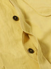 Close-up of the Lemon Linen Slub Weave Jungle Jacket, showcasing the lemon-yellow linen fabric, button details, and pocket. The jacket is neatly laid out on a flat surface.