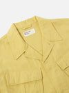 Close-up of the Lemon Linen Slub Weave Jungle Jacket on a plain background. The jacket is a light yellow color and made of linen. It has a relaxed fit and visible pockets.