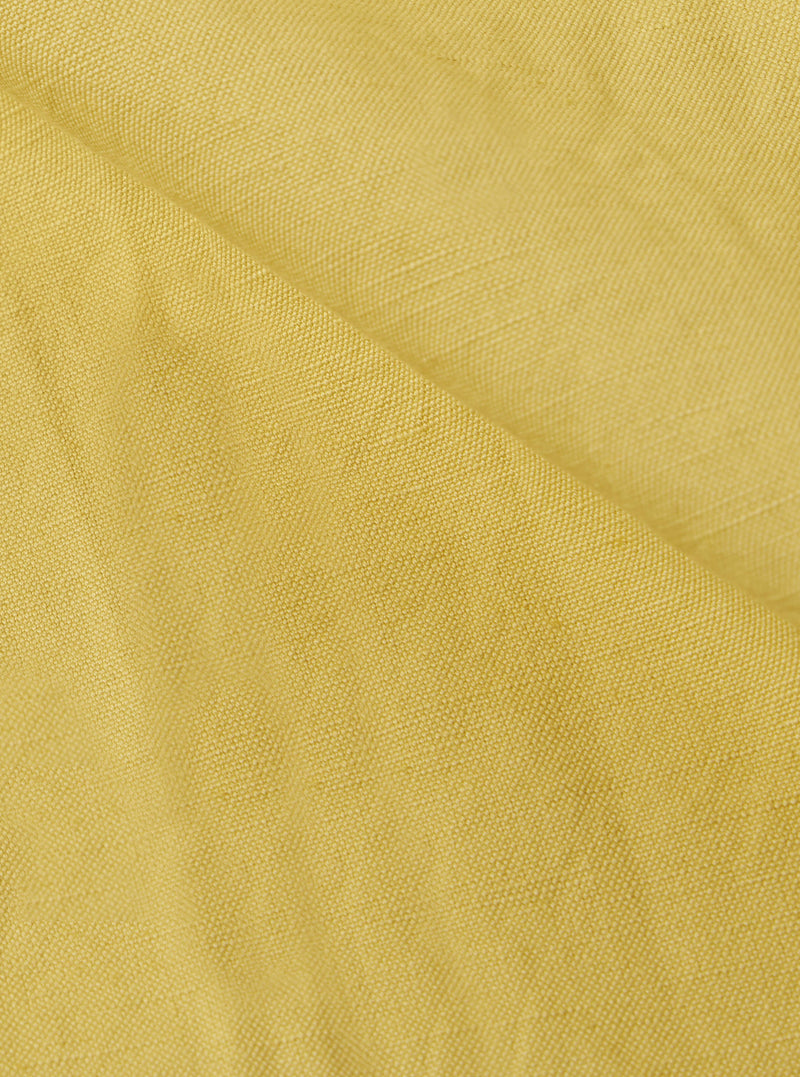 Close-up of the lemon-colored linen slub weave of the Jungle Jacket. The fabric's texture is visible, showcasing its natural fibers and subtle variations in color.