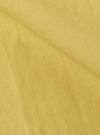 Close-up of the lemon-colored linen slub weave of the Jungle Jacket. The fabric's texture is visible, showcasing its natural fibers and subtle variations in color.