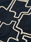 Close-up of the Navy Mitla Broadcloth Club Jacket showing the navy fabric and the cream-colored embroidered design. The jacket is laid flat on a neutral surface.