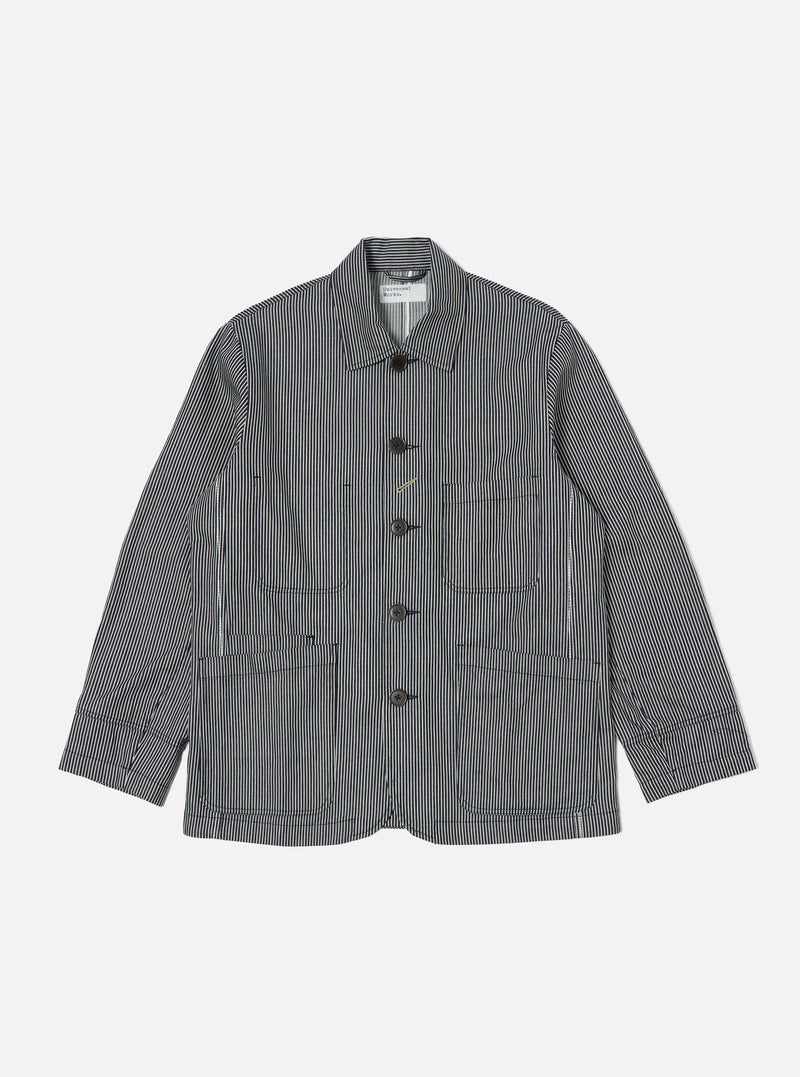 The Indigo Hickory Stripe Denim Original Bakers Jacket is laid flat on a white background. The jacket is blue and white striped denim with brown buttons.