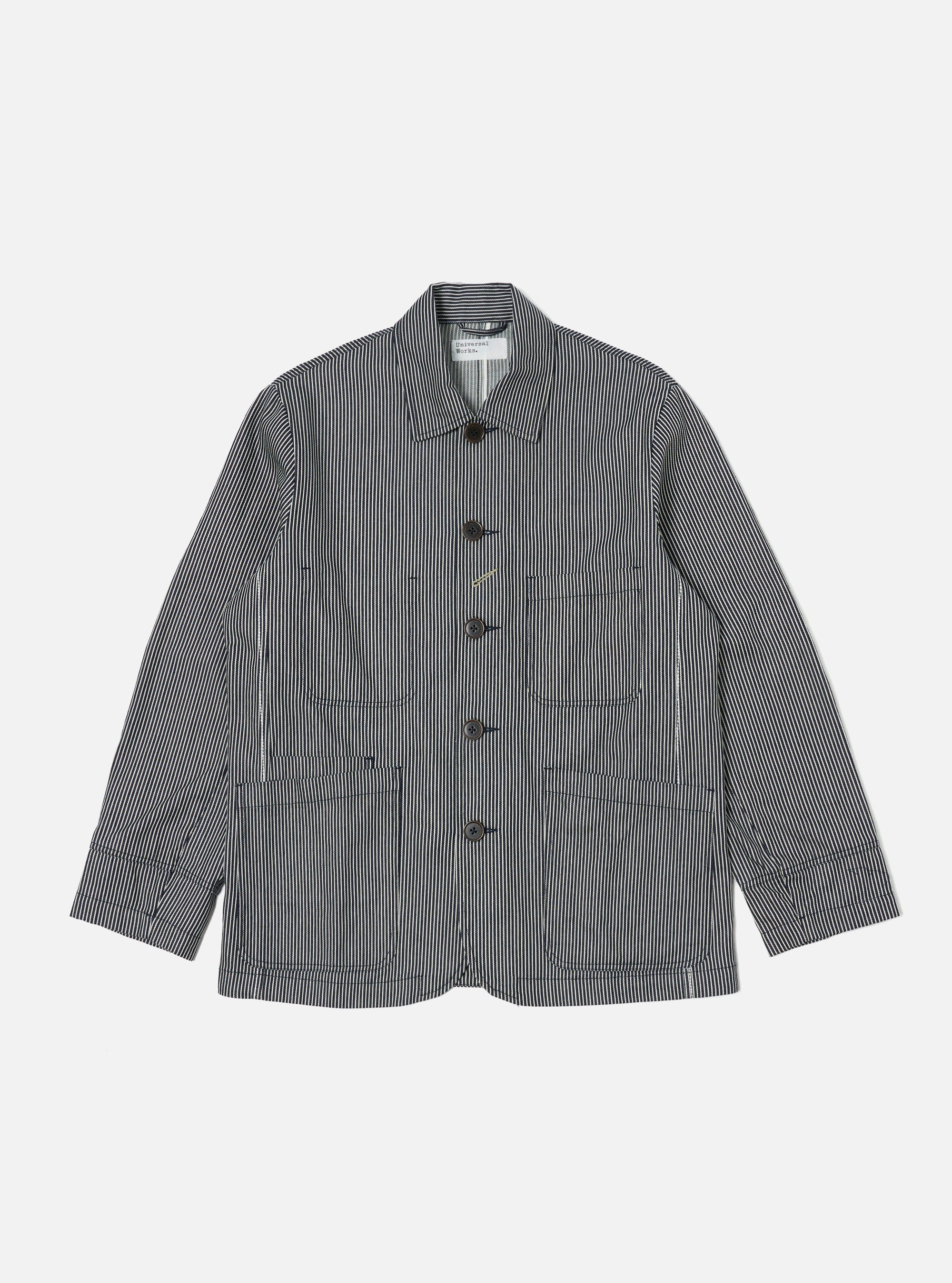 The Indigo Hickory Stripe Denim Original Bakers Jacket is laid flat on a white background. The jacket is blue and white striped denim with brown buttons.