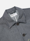 Close-up of the Indigo Hickory Stripe Denim Original Bakers Jacket. Features a blue and white striped pattern, button closure, and a classic collar. Shot on a white background.