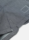 Close-up of the Indigo Hickory Stripe Denim Original Bakers Jacket. The jacket features a blue and white striped pattern and is made of durable denim material.