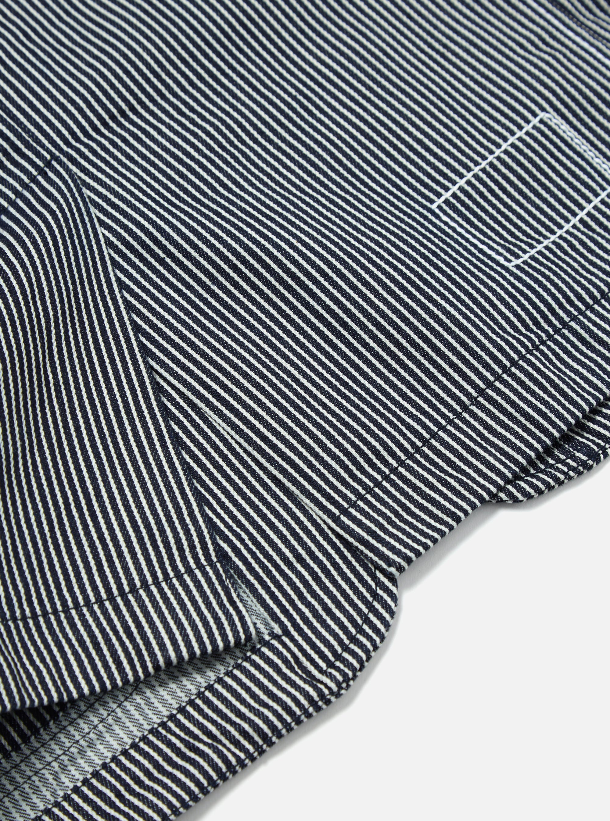 Close-up of the Indigo Hickory Stripe Denim Original Bakers Jacket. The jacket features a blue and white striped pattern and is made of durable denim material.