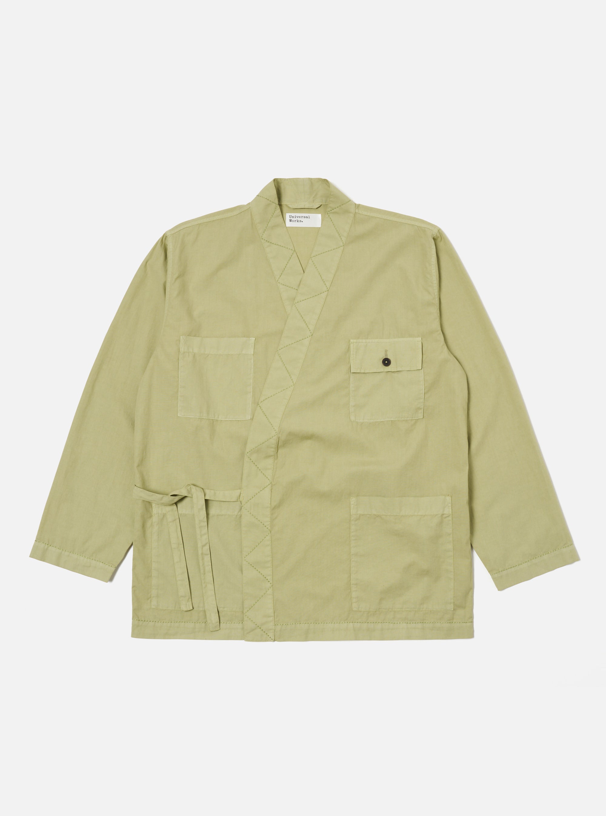 Pale green broadcloth Osaka Work Jacket on a white background. The jacket has a tie waist, pockets, and a relaxed fit.