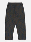 Back view of the Navy Mitla Print Cotton Hi Water Trouser on a white background. The trousers feature a navy print on a brown cotton fabric and a relaxed fit.