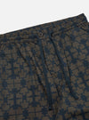 Close-up of the Navy Mitla Print Cotton Hi Water Trouser on a white background. The trousers have a navy blue geometric print and a button closure.
